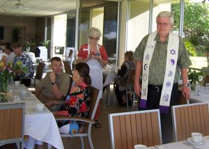 man with interfaith symbols on vestment